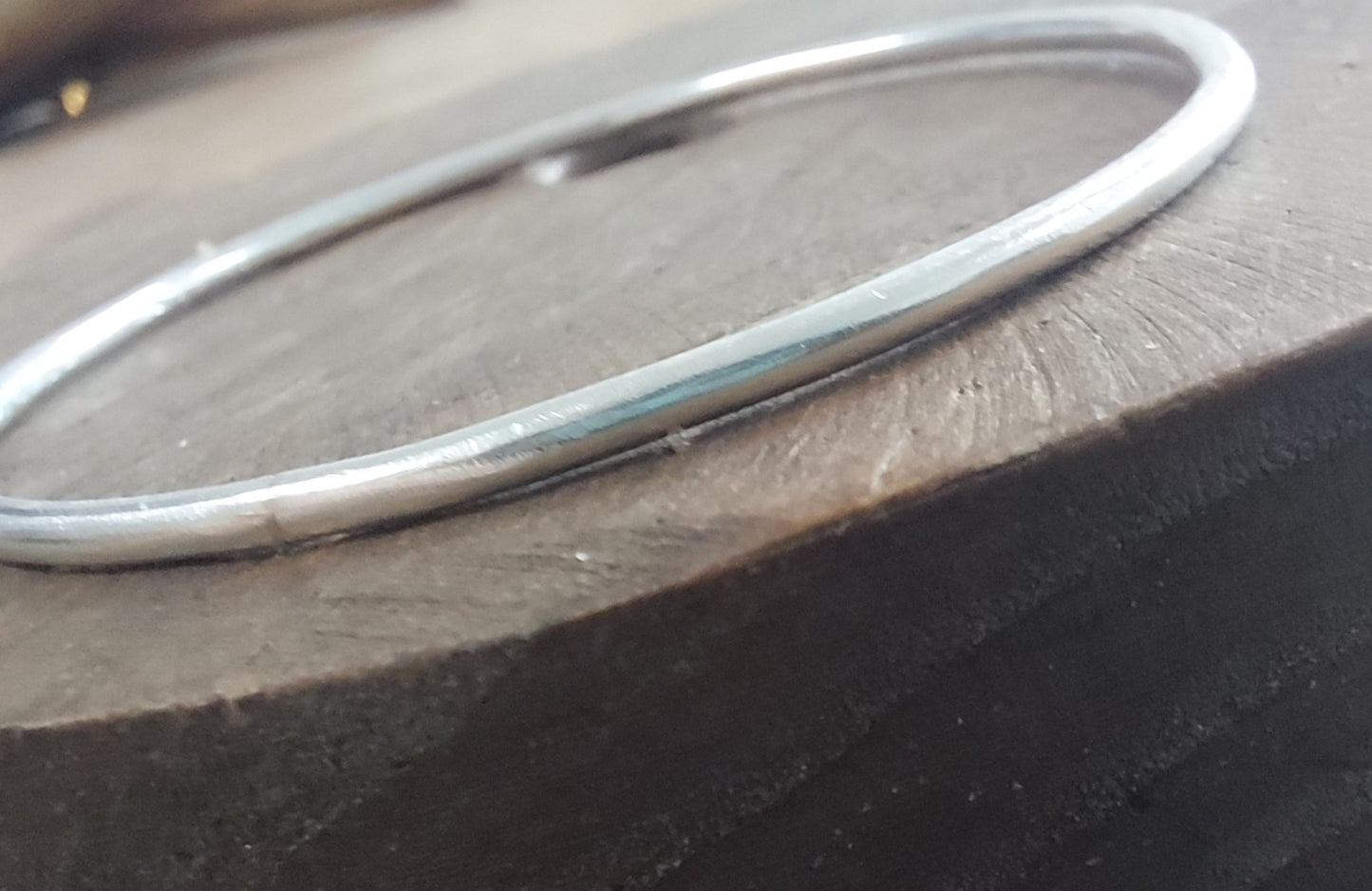 Silver bracelet on a wooden surface