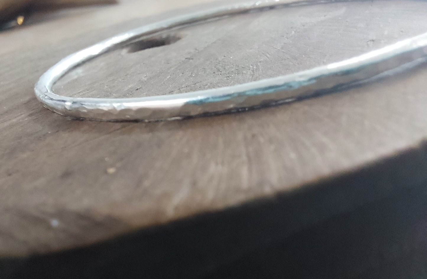 Silver bracelet on a wooden surface