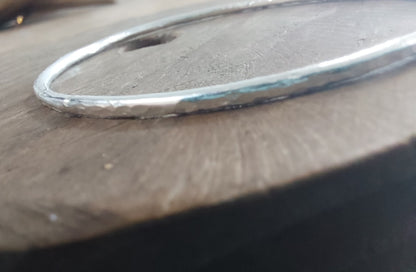 Silver bracelet on a wooden surface