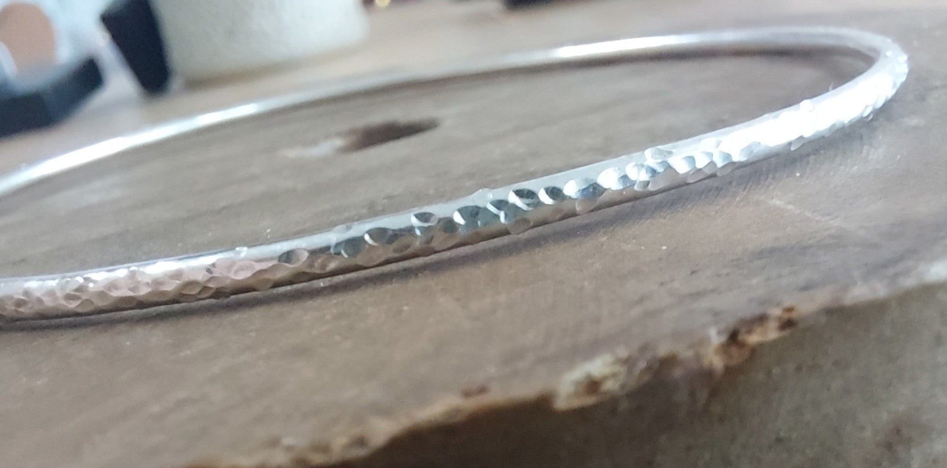 Silver bracelet on a wooden surface