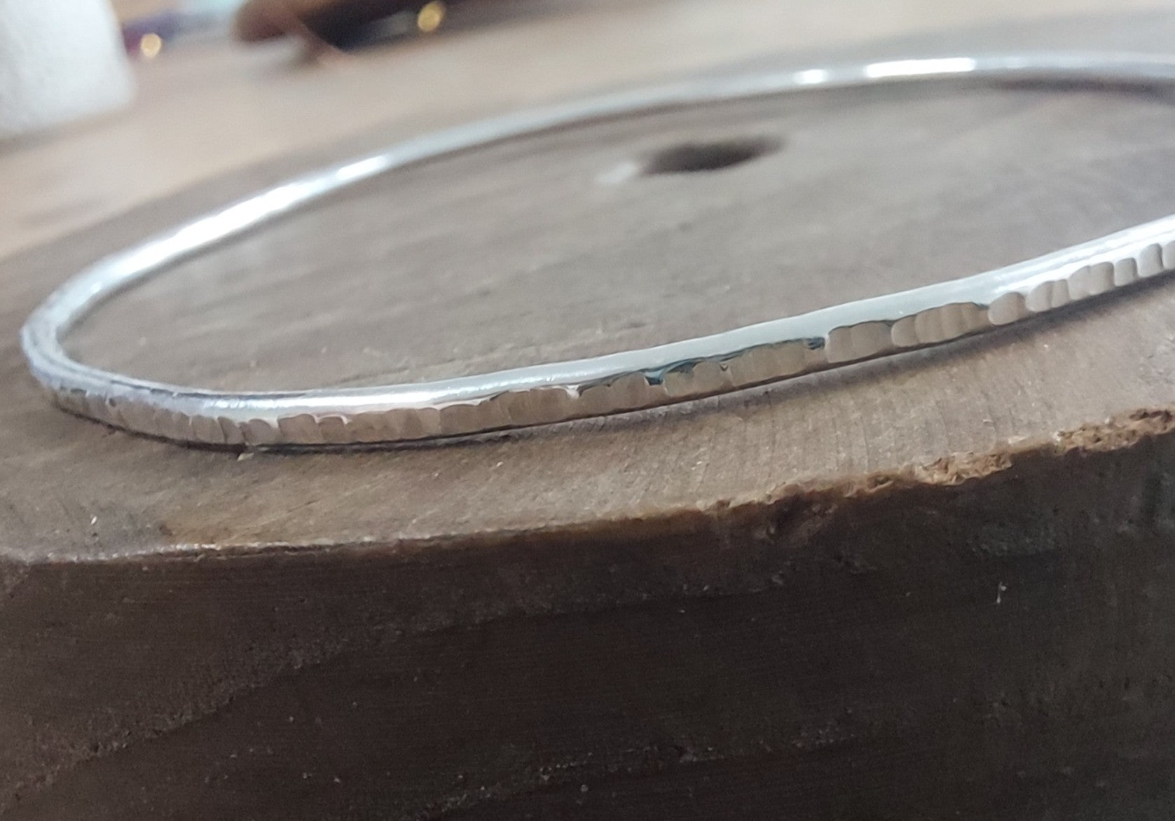 Silver bracelet on a textured surface