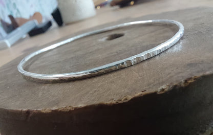 Silver bracelet on a wooden surface